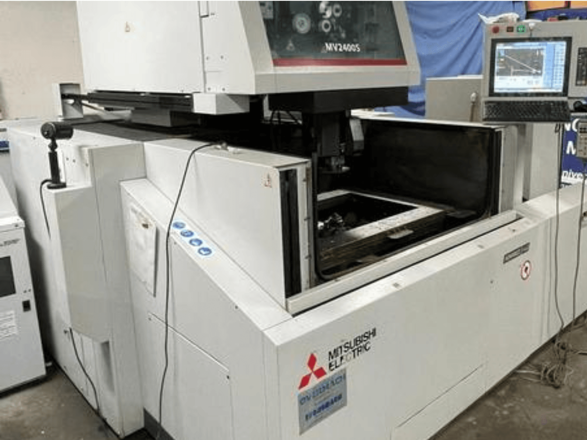 Stroj za žičano rezanje Mitsubishi Electric MV2400S, prednji pogled, prikazuje upravljačku ploču i otvoreni radni prostor.