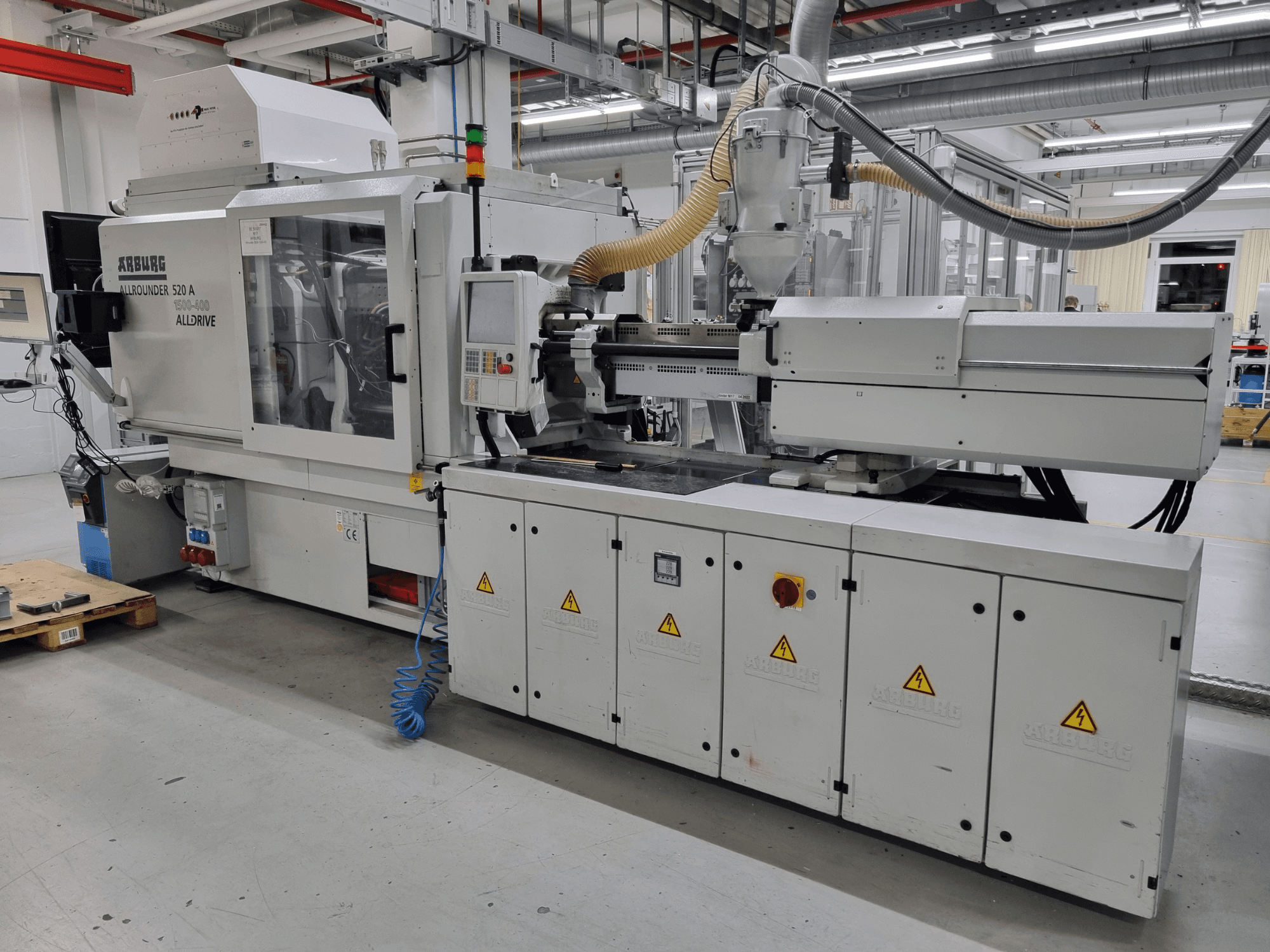 Stroj za brizganje plastike Arburg Allrounder 520 A, bočni pogled, s prikazom upravljačke ploče i sigurnosnih značajki.