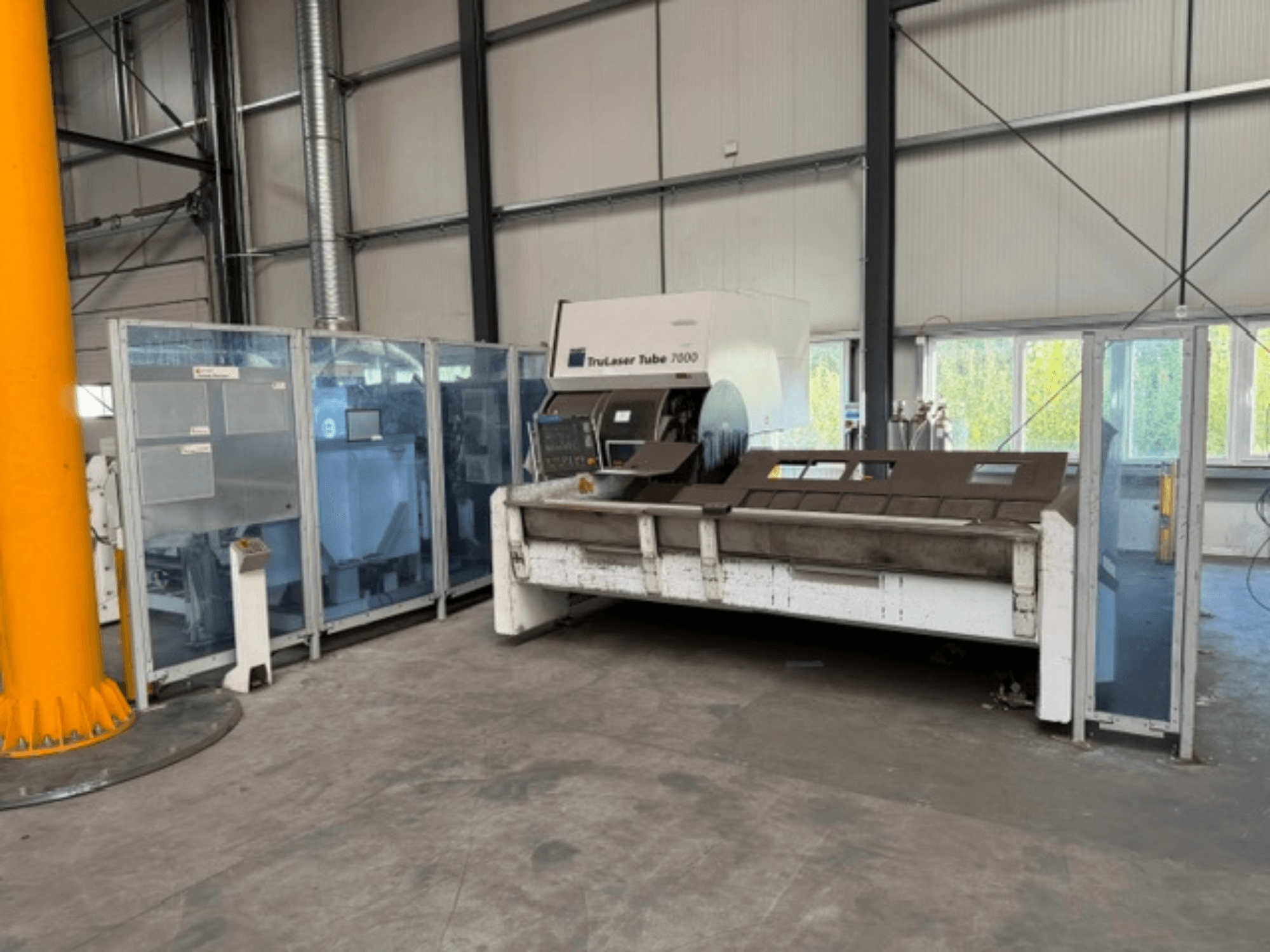 TruLaser Tube 7000 tvrtke TRUMPF, prednji pogled na stroj za rezanje cijevi u dobro osvijetljenom industrijskom okruženju s vidljivim upravljačkim elementima.