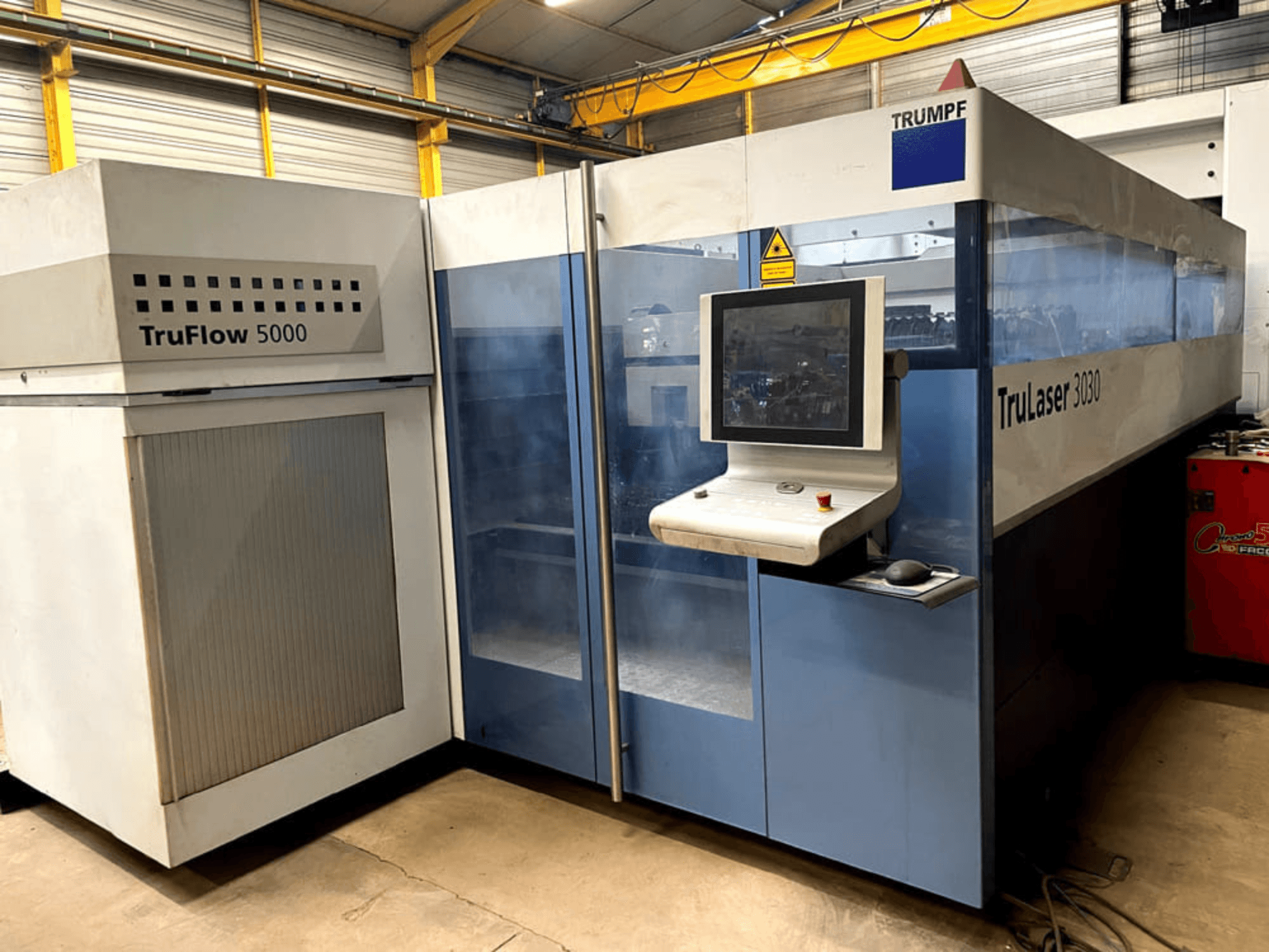TRUMPF TruLaser 3030 CO2 laserski stroj za rezanje u prednjem pogledu, s upravljačkom pločom i susjednom TruFlow 5000 jedinicom.