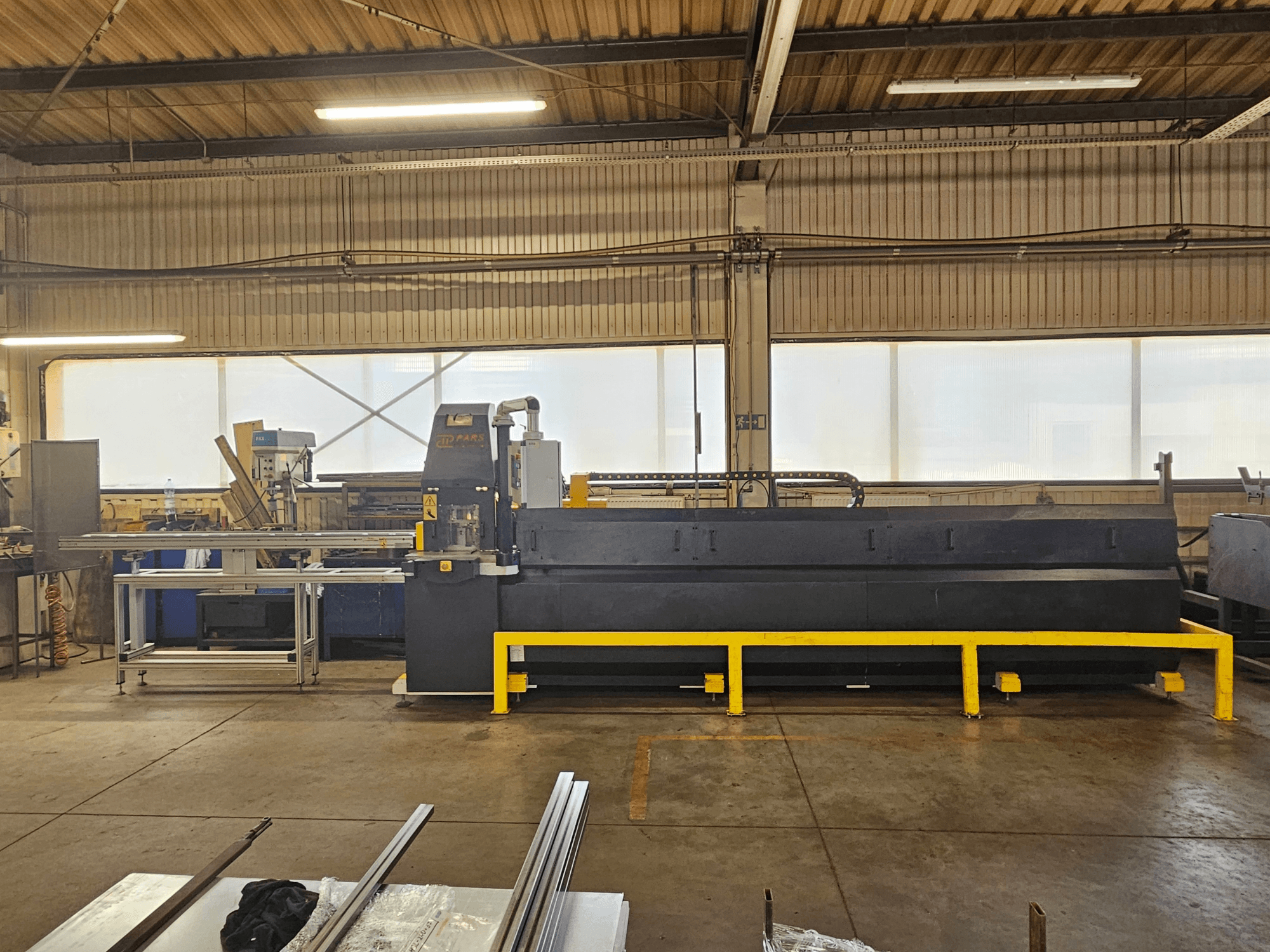 CNC stroj za probijanje PARS HMP SIRIUS PLUS-3000/3-L1, prednji pogled u industrijskom okruženju s metalnom površinom i alatima.