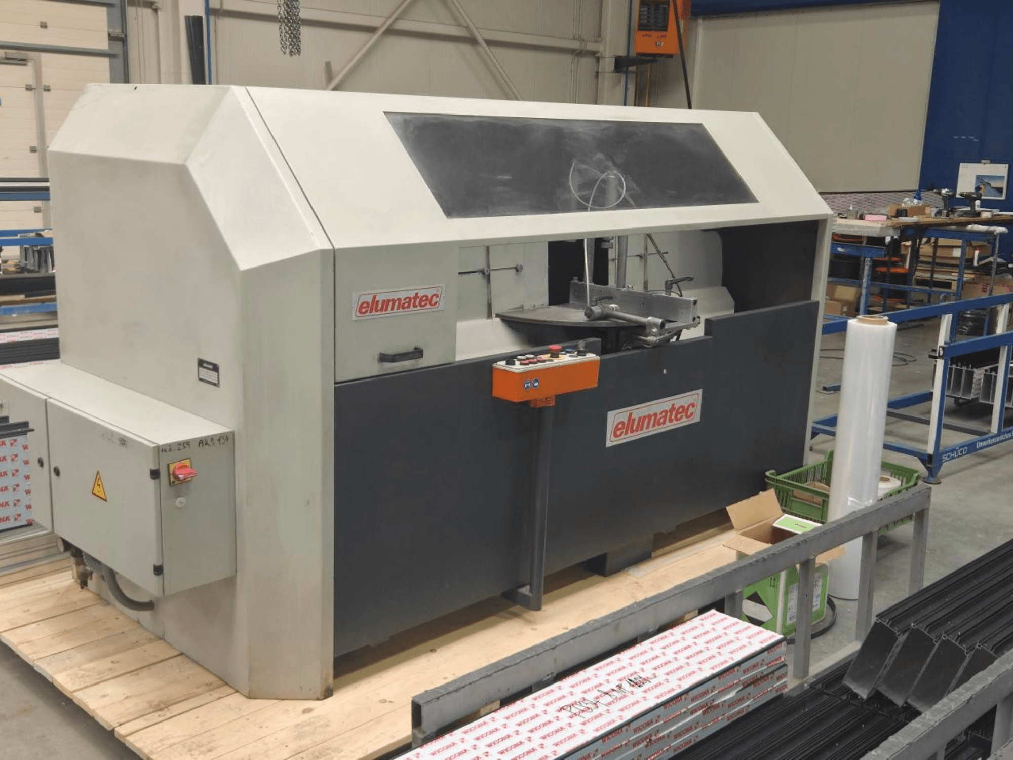 Kružna pila za metal Elumatec AKS 134, pogled sprijeda, s prikazom upravljačke ploče i područja rezanja na drvenoj platformi.