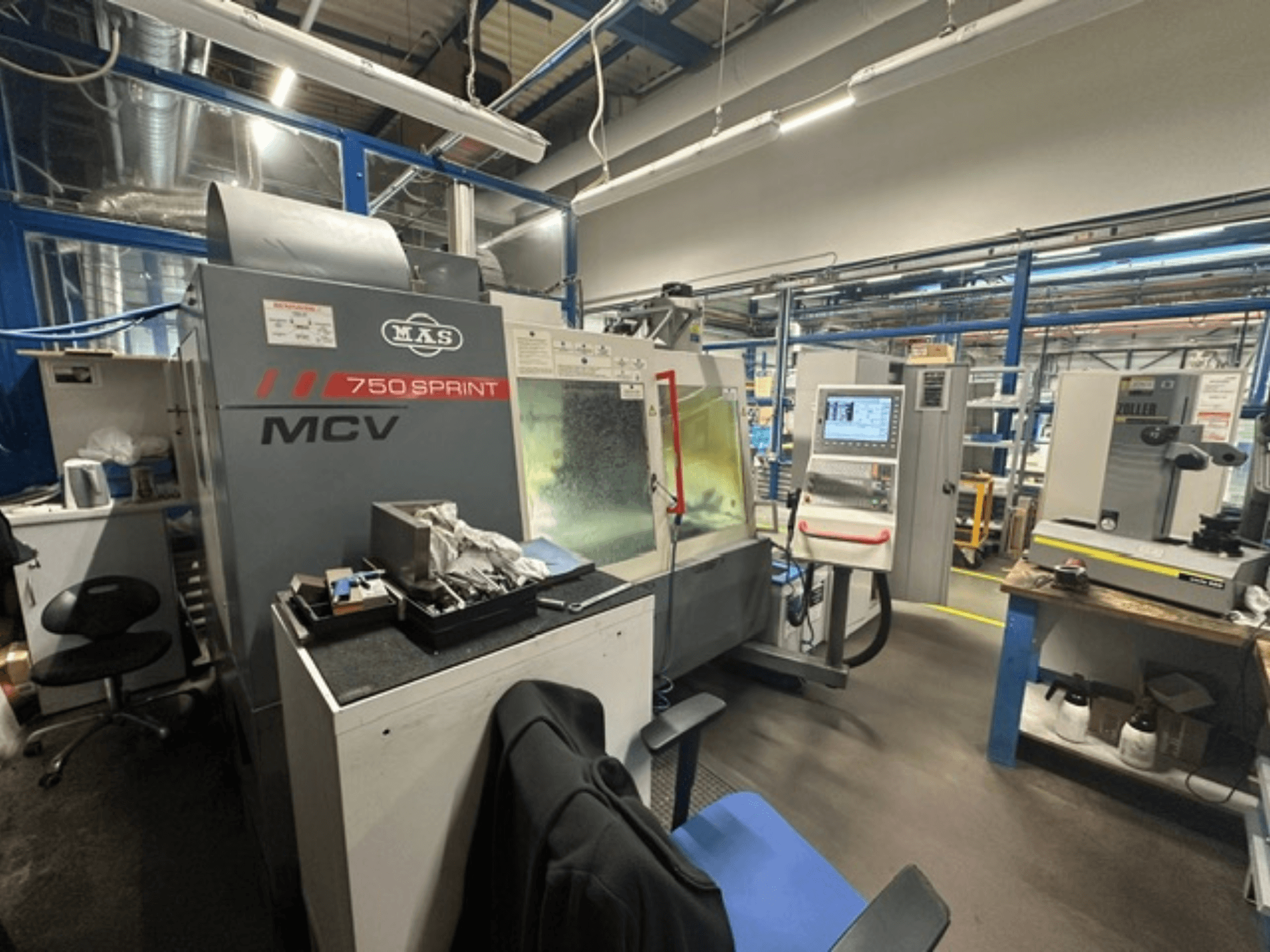 Vertikalni obradni centar KOVOSVIT MAS MCV 750 Sprint u radionici, s prikazom upravljačke ploče i radnog prostora iz bočnog pogleda.