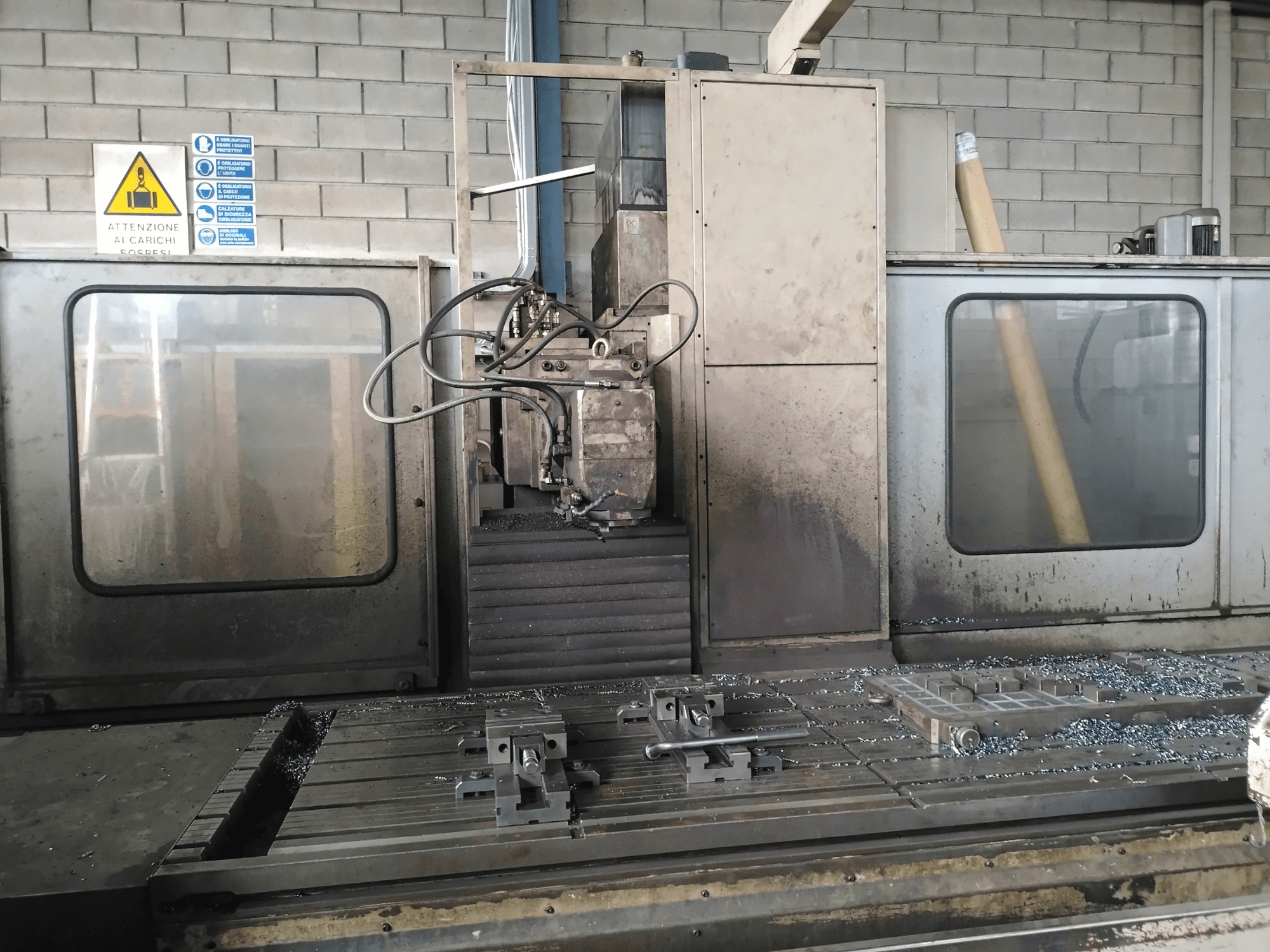 Glodalica s krevetom TIGER TFA6 u radionici, prednji pogled s alatima i metalnim strugotinama na stolu.