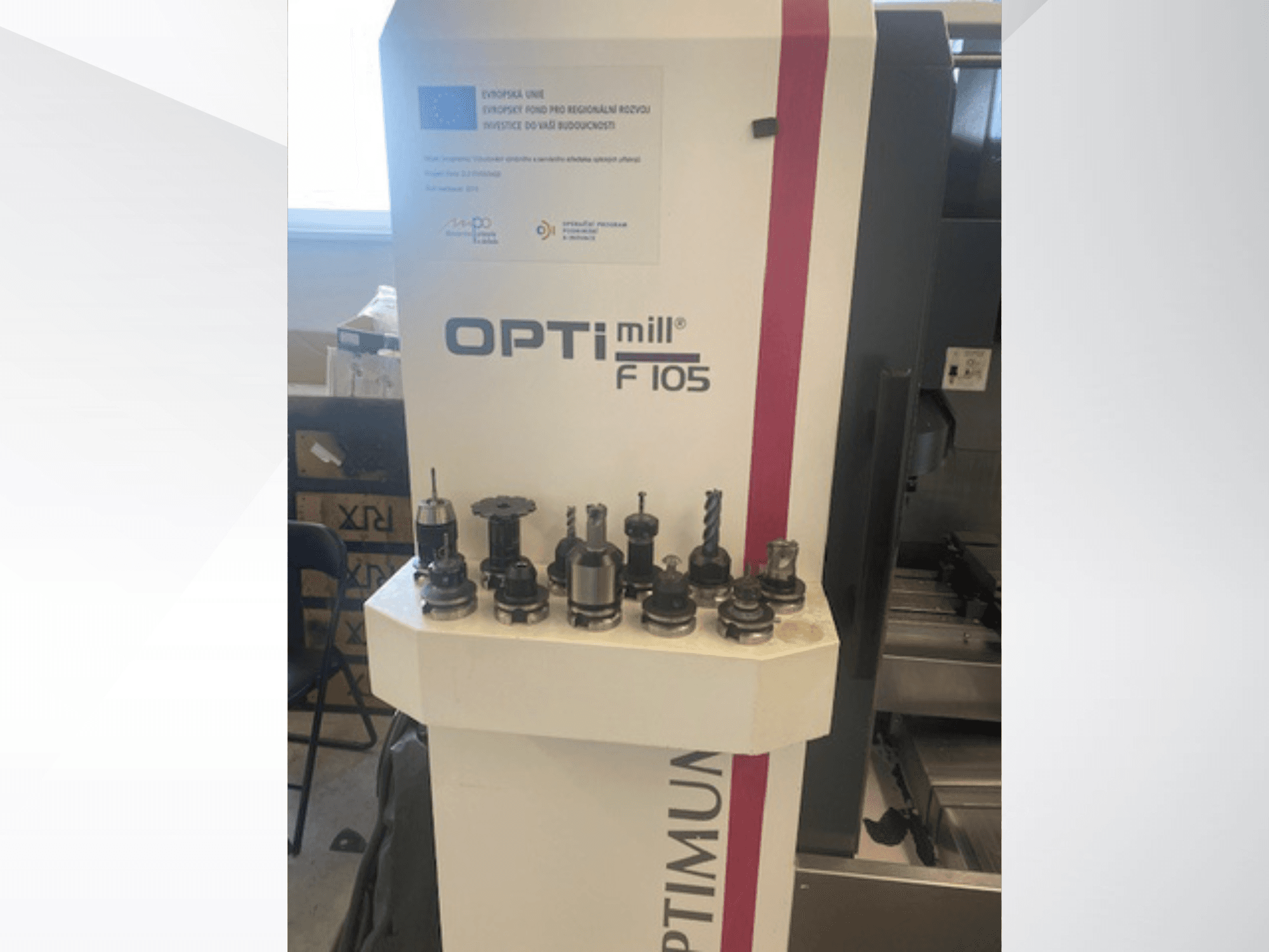 Prednji pogled na vertikalni obradni centar Optimum Optimill F105 s raznim priključenim alatima prikazanim sa strane.