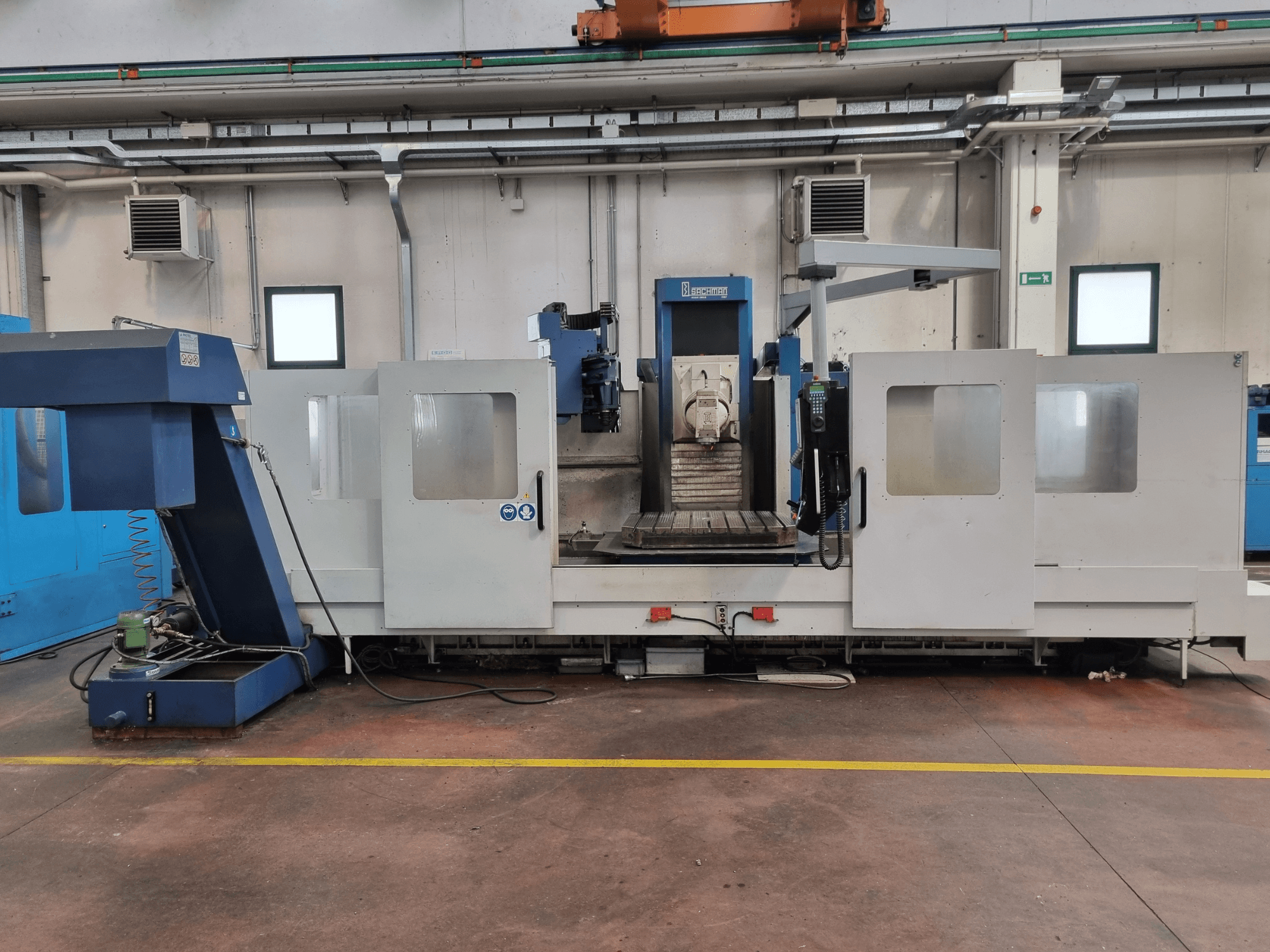 CNC glodalica tvrtke "Brembana", bočni pogled koji prikazuje upravljačku ploču i operativni prostor s radnim stolom unutra.