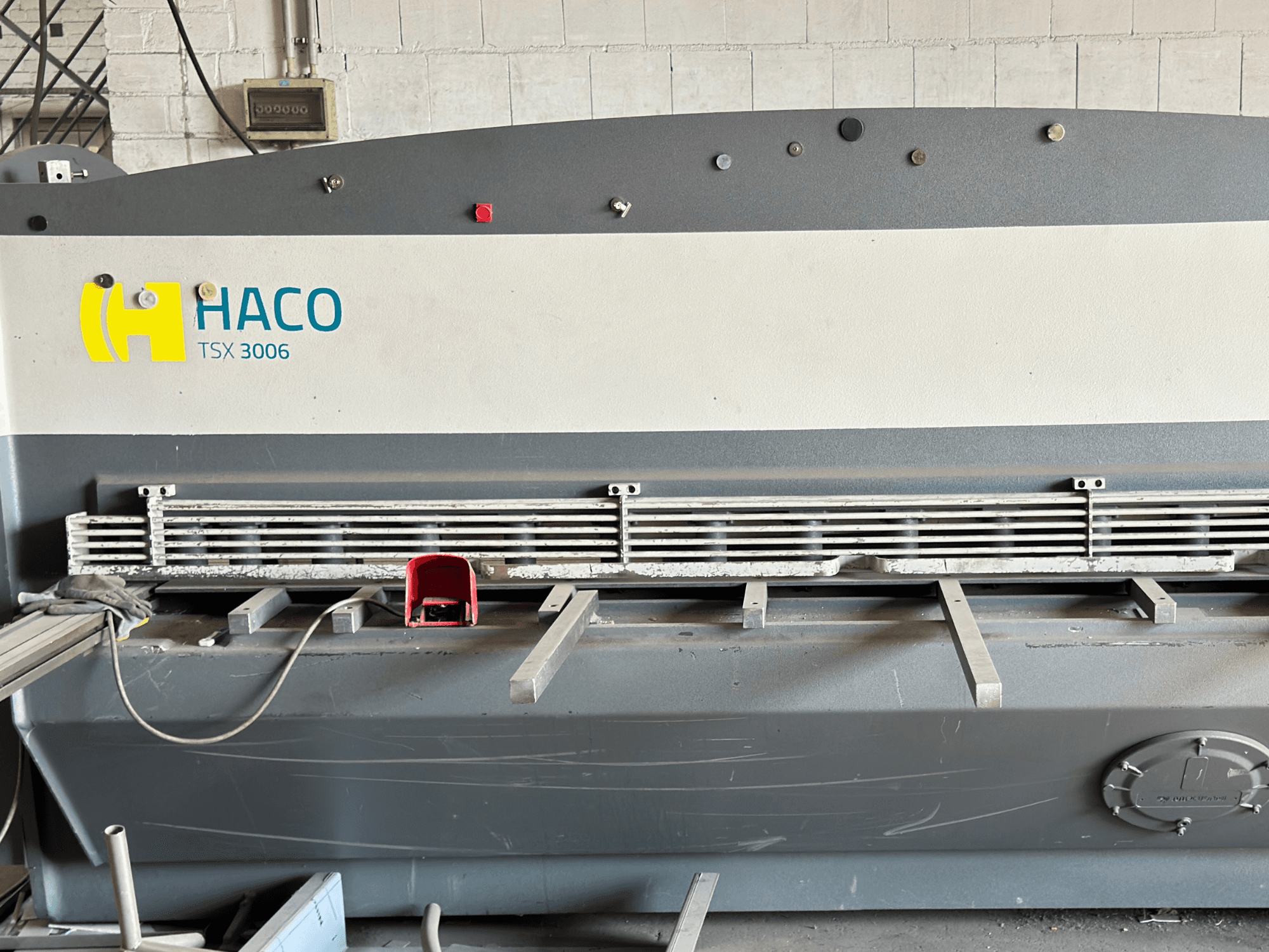 HACO TSX3006 MOT hidraulički stroj za rezanje, prednji pogled, s metalnim oštricama za rezanje i upravljačkom pločom, s prikazom operativnih detalja.